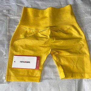 Still in bag new MitaOGirl biker shorts size medium yellow.
